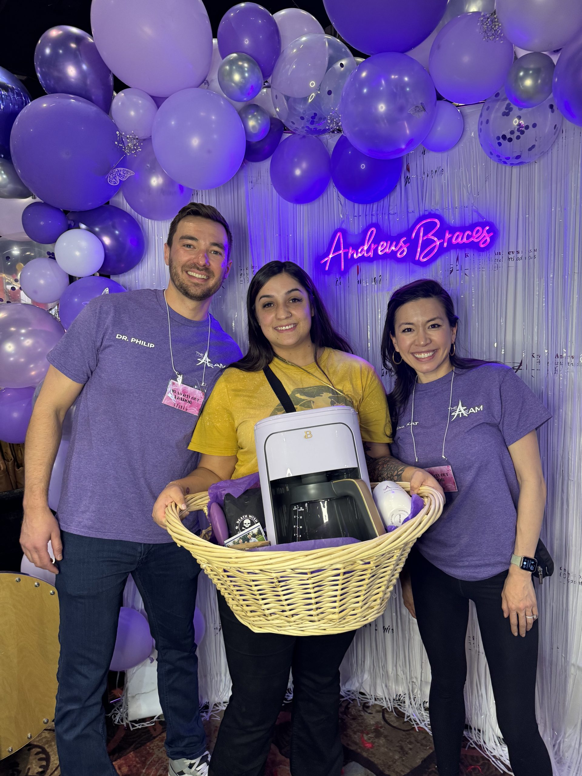Dr. Philip, a Reno-Sparks orthodontist is standing next to the raffle winner, who is standing next to Dr. Kat, A reno-Sparks orthodontist