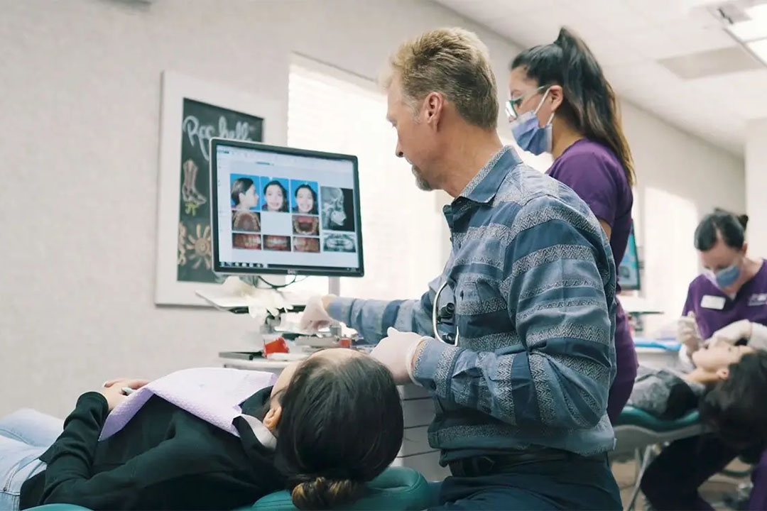 Dr. Kevin treating patient on the chair